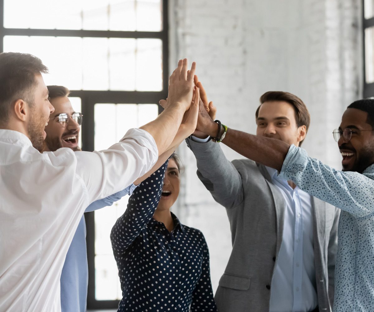 Employees-high-fiving-each-other-after-successful-traditional-labor-negotiations