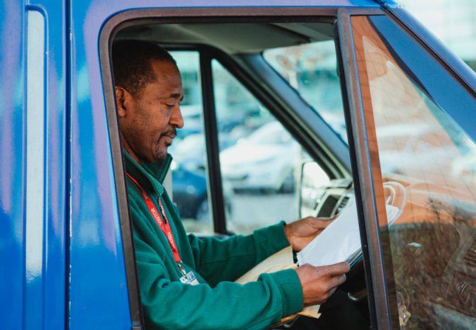 Employee-reviewing-documents-in-truck-to-prevent-misclassification Employee-reviewing-documents-in-truck-to-prevent-misclassification