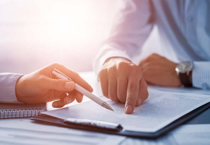 Employee-reviewing-employment-contract-with-restrictive-covenant-clause Employee-reviewing-employment-contract-with-restrictive-covenant-clause