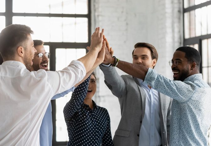 Employees-high-fiving-each-other-after-successful-traditional-labor-negotiations Employees-high-fiving-each-other-after-successful-traditional-labor-negotiations