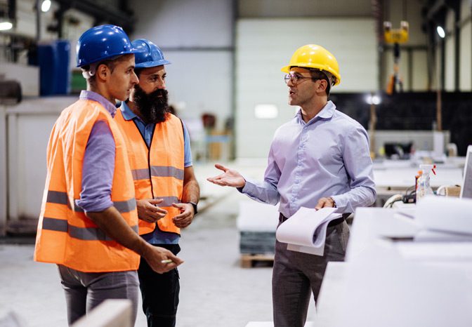Engineers-wearing-hard-hats-to-maintain-workplace-safety Engineers-wearing-hard-hats-to-maintain-workplace-safety