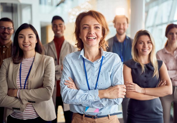 Group-of-employees-standing-with-hands-folded-after-successful-union-negotiations Group-of-employees-standing-with-hands-folded-after-successful-union-negotiations