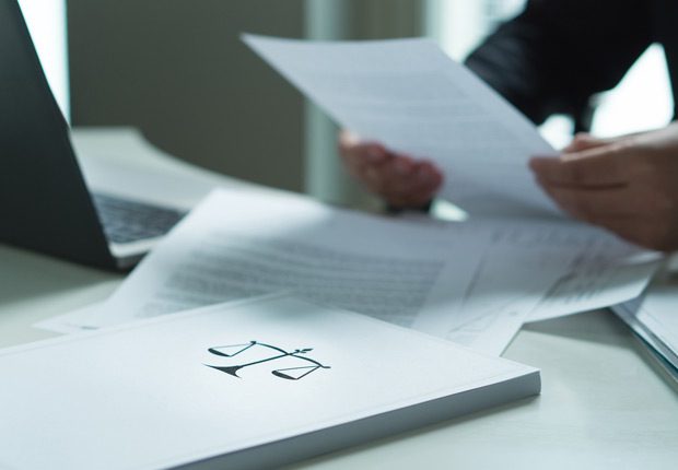 Lawyer-reviewing-breach-of-contract-lawsuit Lawyer-reviewing-breach-of-contract-lawsuit