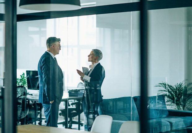 Managers-discussing-law-to-avoid-FMLA-violations Managers-discussing-law-to-avoid-FMLA-violations