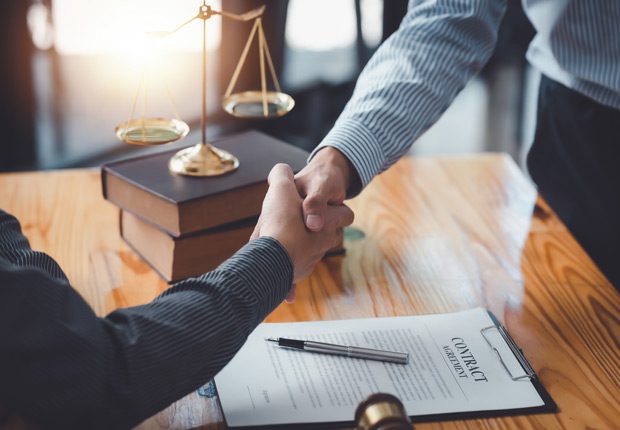 Two-people-shaking-hands-after-signing-a-non-compete-agreement Two-people-shaking-hands-after-signing-a-non-compete-agreement