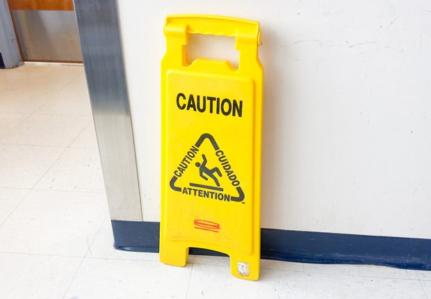 Wet-floor-sign-posted-to-prevent-OSHA-violation Wet-floor-sign-posted-to-prevent-OSHA-violation