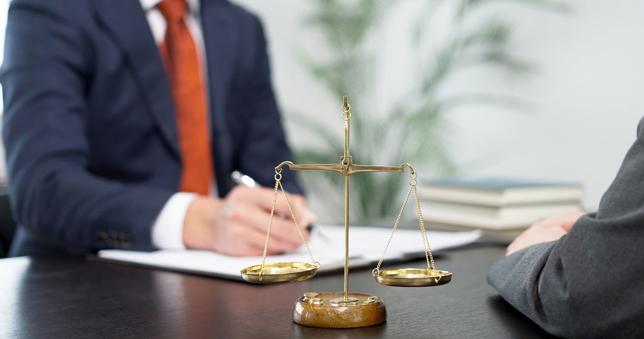 Lawyer-consulting-with-client-while-reviewing-documents