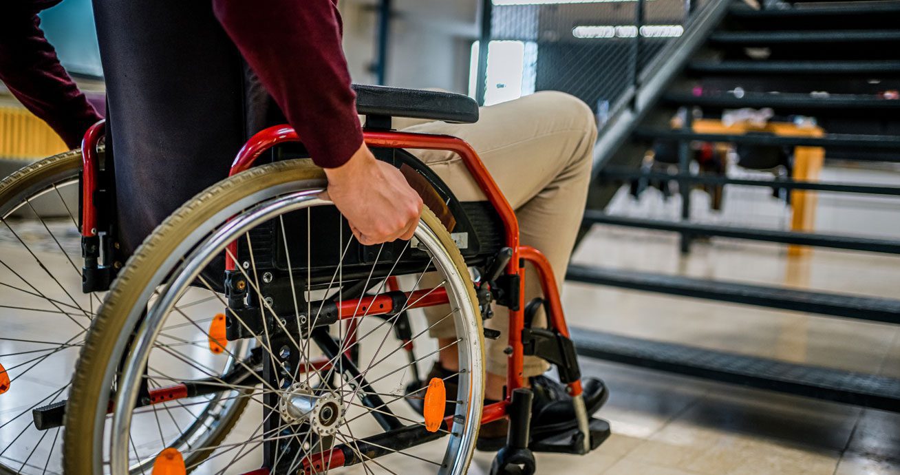 Man-sitting-in-wheelchair-indoors