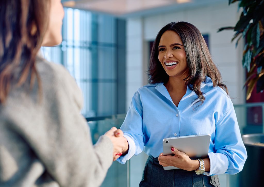 two-women-shaking-hands-in-an-office