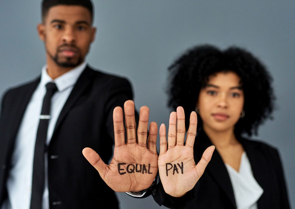 man-and-woman-holding-up-palms-reading-equal-pay
