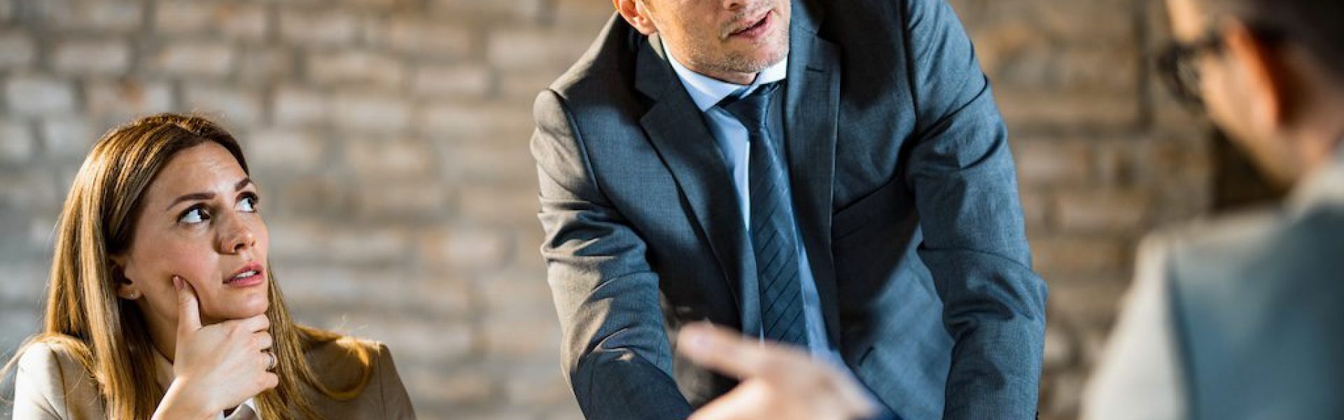 man-standing-and-speaking-during-a-team-meeting